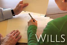 person-signing-legal-paperwork-wills
